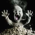 screaming baby covered in ash. arms raised and mouth agape.